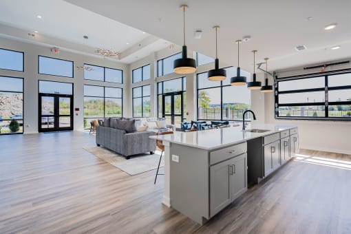 a large kitchen with a large island and a living room