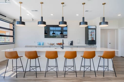a kitchen with a counter top and chairs