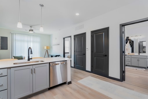 an open kitchen and living room with a sink and a counter