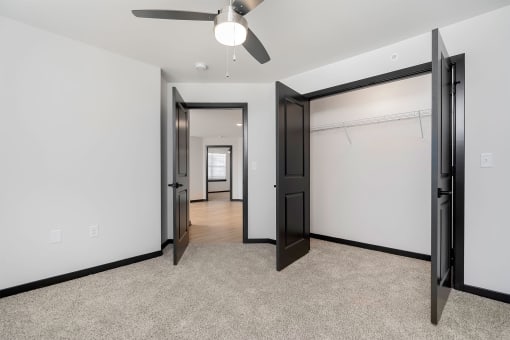 a bedroom with a closet and a ceiling fan