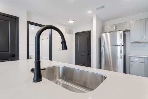 kitchen sink and a stainless steel fridge