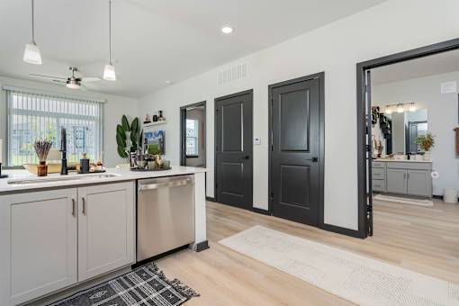 A modern kitchen with wooden floors and a large island.