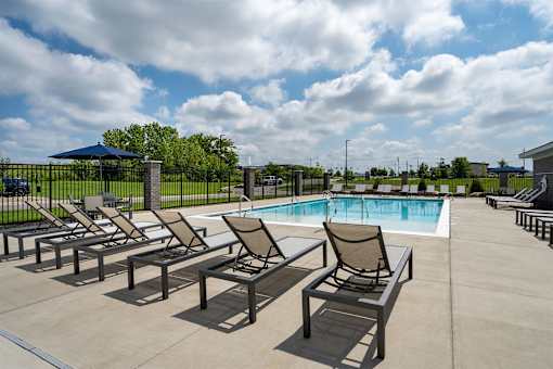 A poolside area with chairs and a pool.
