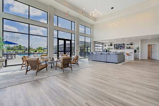 A spacious living room with wooden floors and furniture.