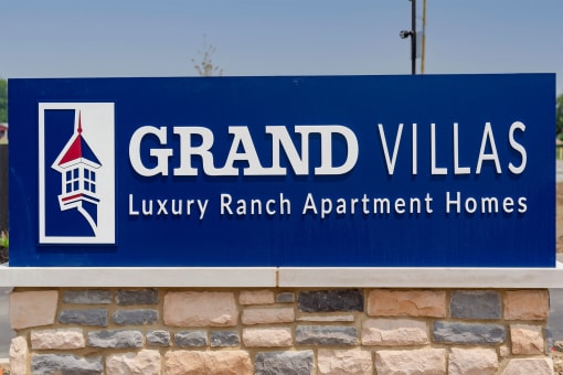 a sign for grand villas luxury ranch apartment homes