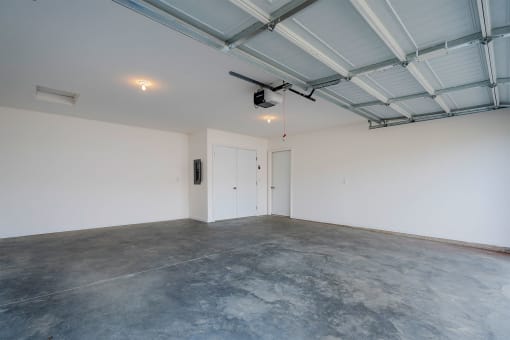 a large room with white walls and a concrete floor