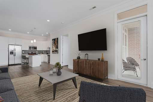 A modern living room with a grey sofa and a wooden coffee table.