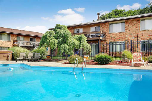 a large swimming pool in front of a building