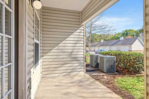 A sunny day at a residential house with a covered porch.