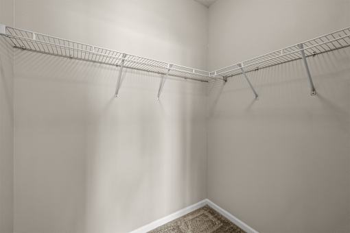 A white closet with a metal rack.