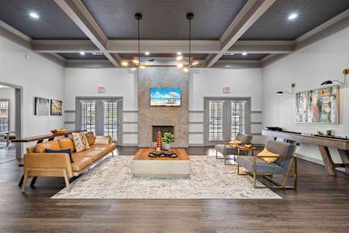 A living room with a fireplace and a TV on the wall.