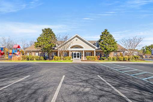 A large building with a parking lot in front of it.