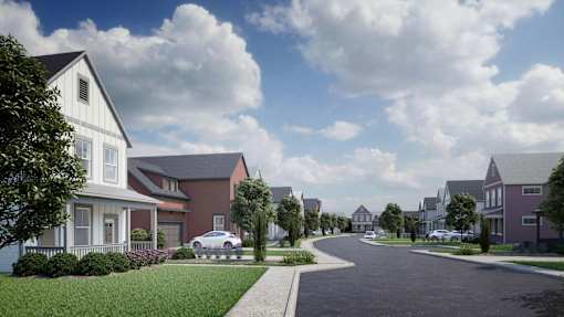 A row of houses with a car parked in front of one.