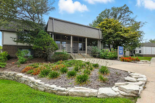 A small building with a landscaped garden in front.