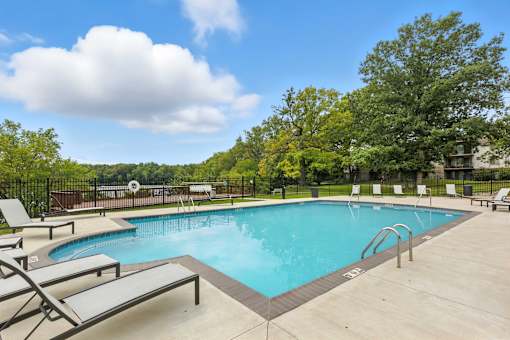 A large outdoor swimming pool surrounded by lounge chairs.