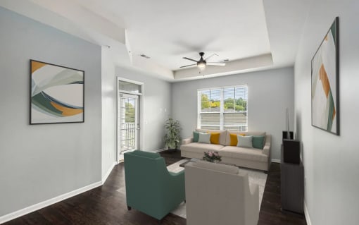 a living room with a couch and a chair and a ceiling fan
