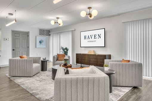 a living room with couches and chairs and a tv
