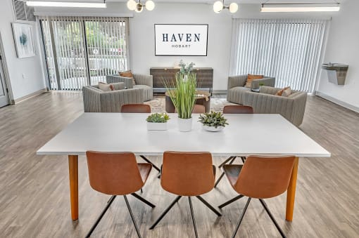 a dining room with a white table and chairs