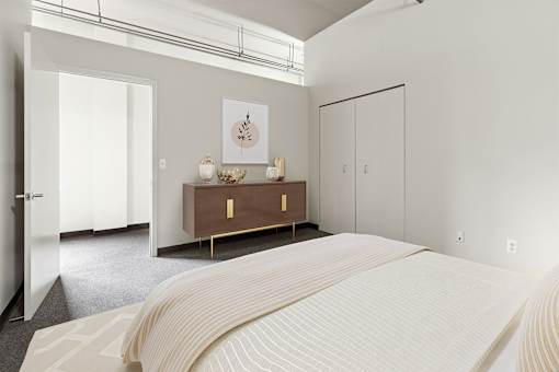 a bedroom with a bed and a dresser