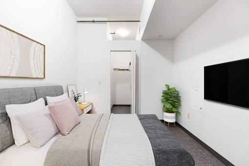 a bedroom with a bed and a tv