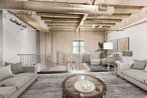 a living room with couches and a coffee table in a loft