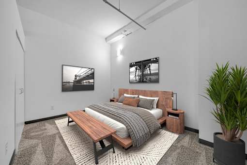 A bedroom with a bed, nightstand, and a potted plant.