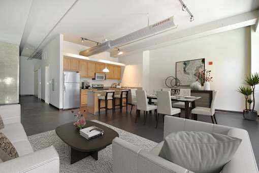 a living room with a couch and a table and a kitchen