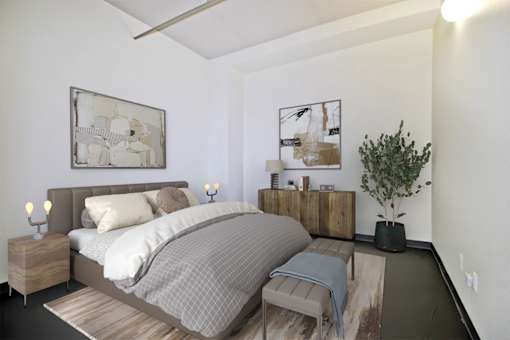 a bedroom with a bed and some pictures on the wall