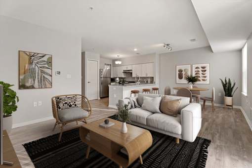 A modern living room with a white sofa, wooden coffee table, and a TV on the left side.