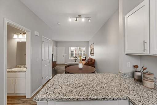 A spacious kitchen with a dining area and a living room.