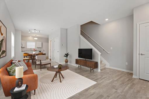 A living room with a couch, a coffee table, and a television.