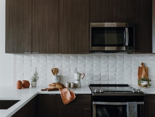 a kitchen with a stove top oven next to a microwave