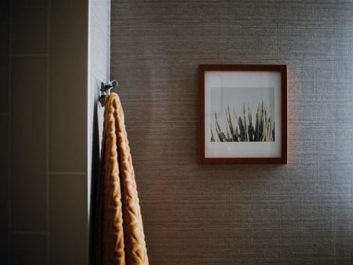a picture hanging on a wall next to a towel
