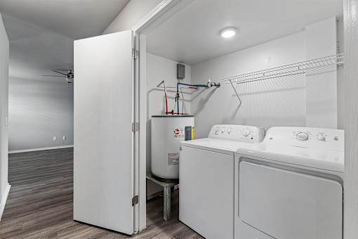 A white laundry room with a washer and dryer.