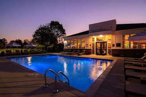 A pool with a building behind it.