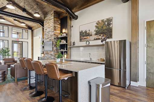 A kitchen with a bar area and a refrigerator.