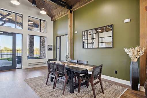 A dining room with a wooden table and chairs.