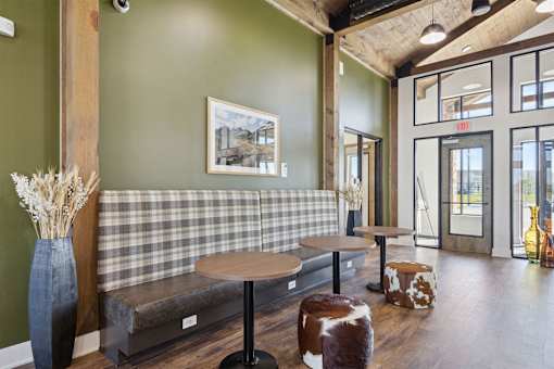 A room with a green wall and a checkered bench.