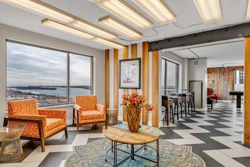 A living room with a view of the ocean through the windows.