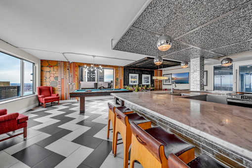 A black and white checkered floor in a room with a pool table.