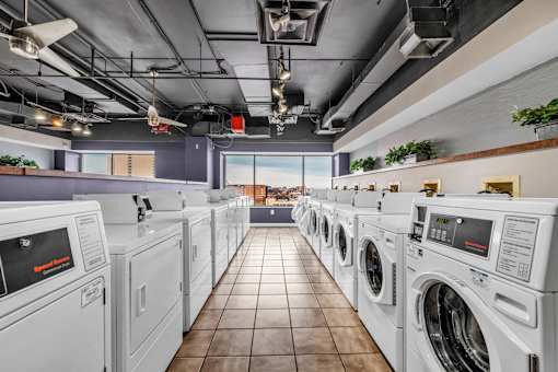 A row of washing machines in a laundromat.