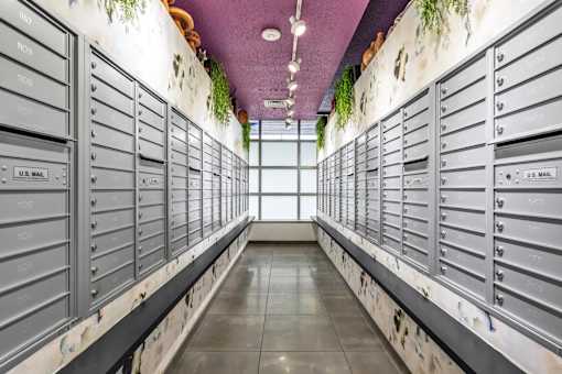 A long hallway of U.S. Mail mailboxes.