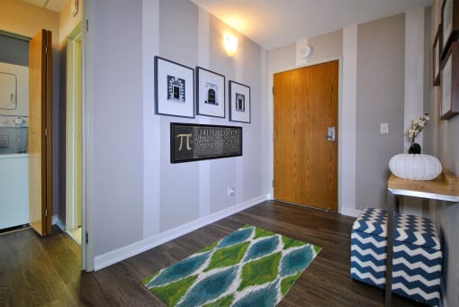 a living room with a rug and pictures on the wall
