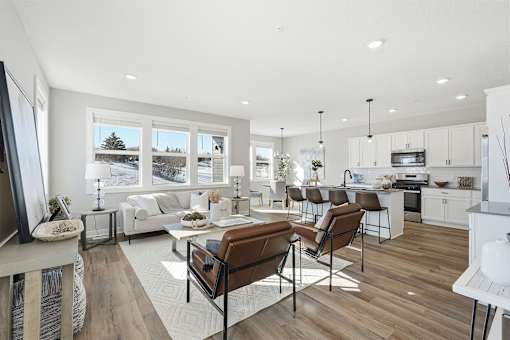 A modern living room with a brown leather chair in the foreground.