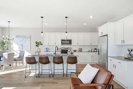 A modern kitchen with white cabinets and a central island.