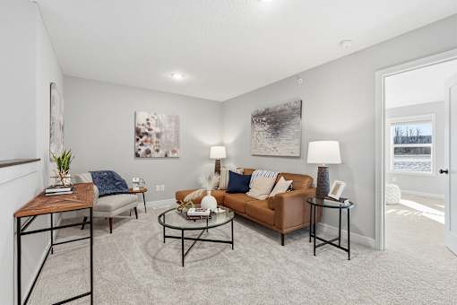 A living room with a couch, coffee table, and two lamps.