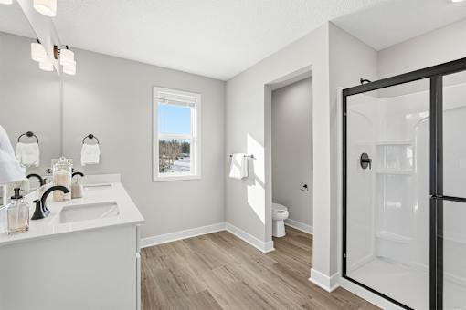 A bathroom with a white sink and a window.