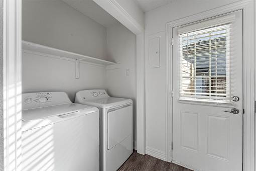 A small laundry room with a washer and dryer.