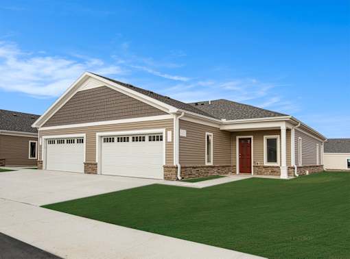 A house with a brown roof and a red door.