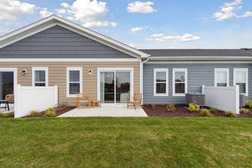 the front of a house with a porch and a lawn